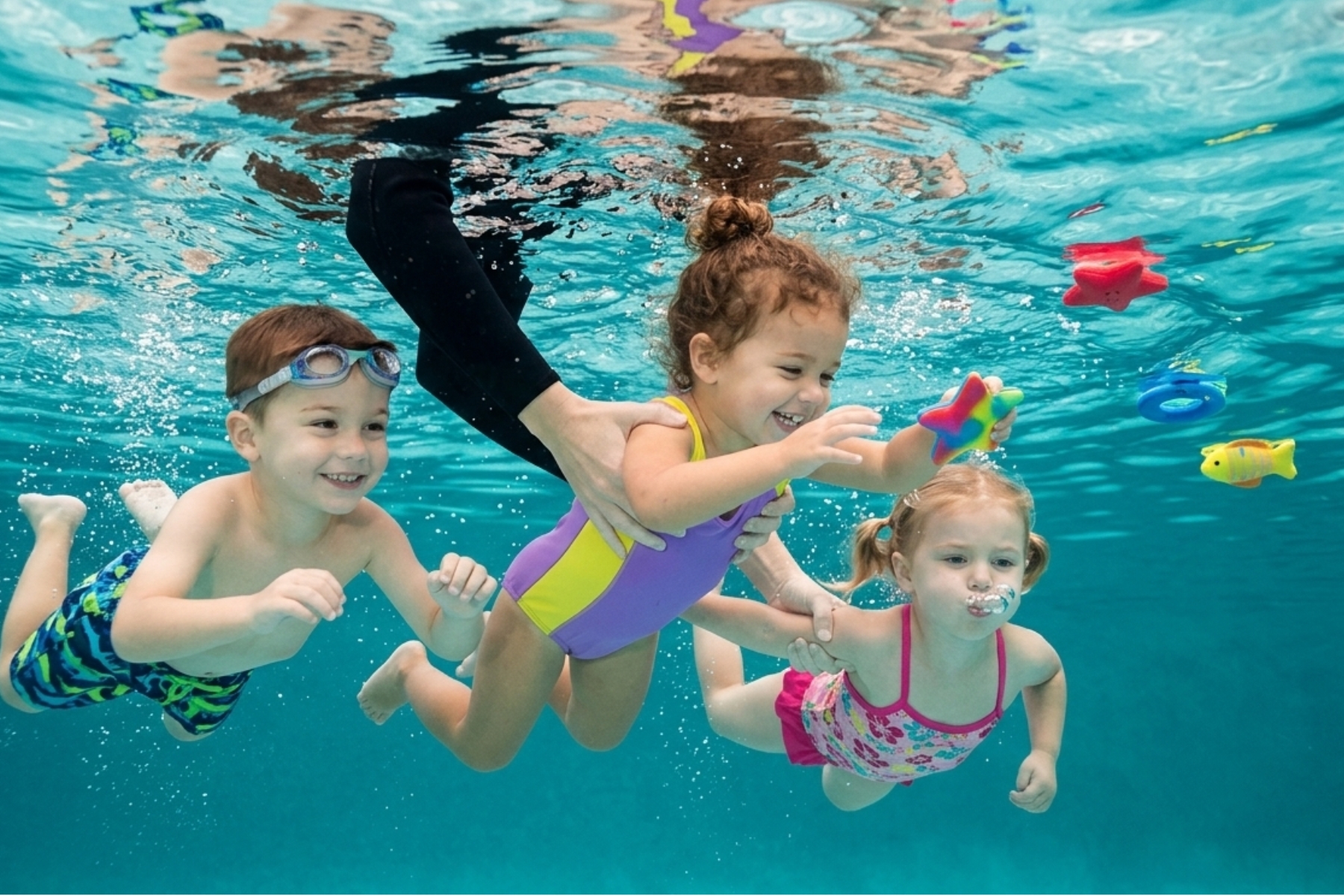 Young children building water confidence in a swim class