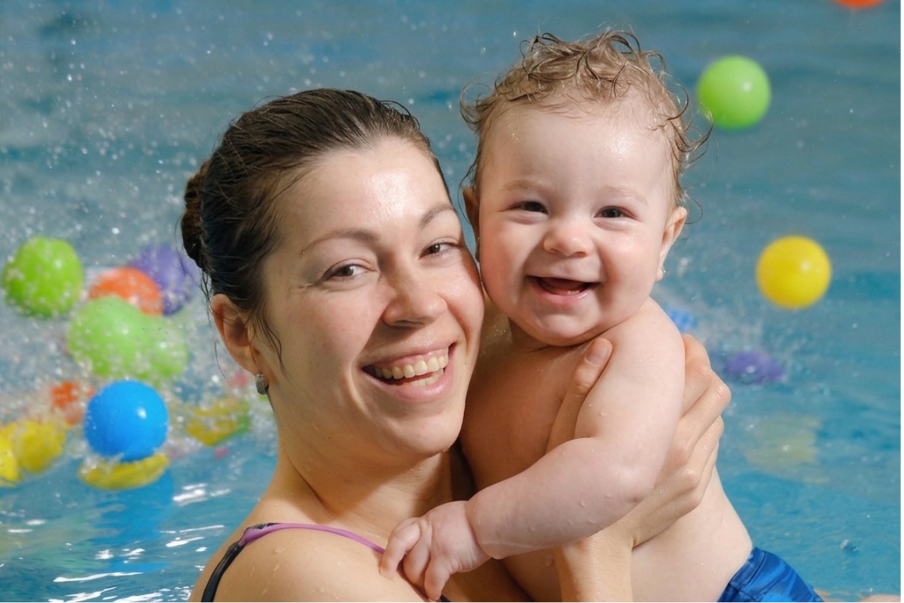 Parent and baby enjoying a swimming lesson together