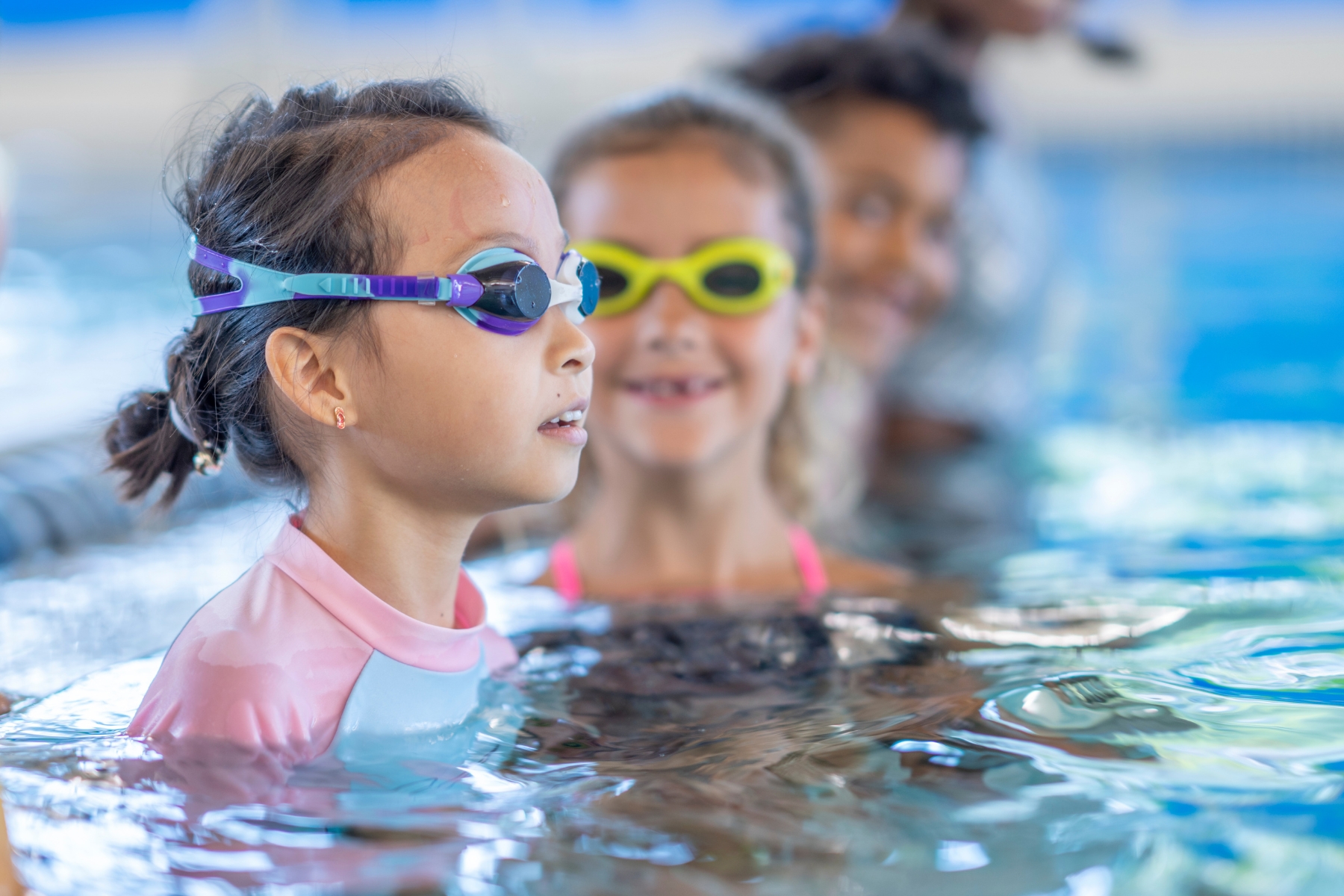 Child practising stroke development in a swimming lesson